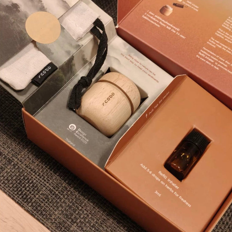 Award-winning minimalist wooden Thai herbal inhaler in a handcrafted jar, professional Thai aromatherapy gift.