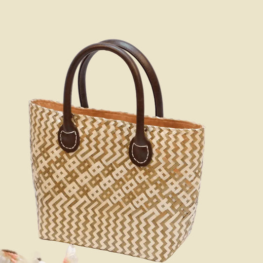 Durable handwoven seagrass boho tote bag with faux leather straps and fabric lining.