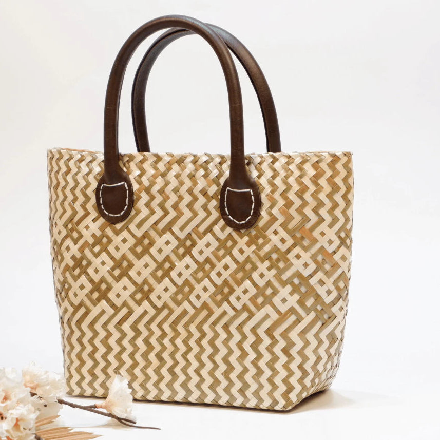 Durable handwoven seagrass boho tote bag with faux leather straps and fabric lining.