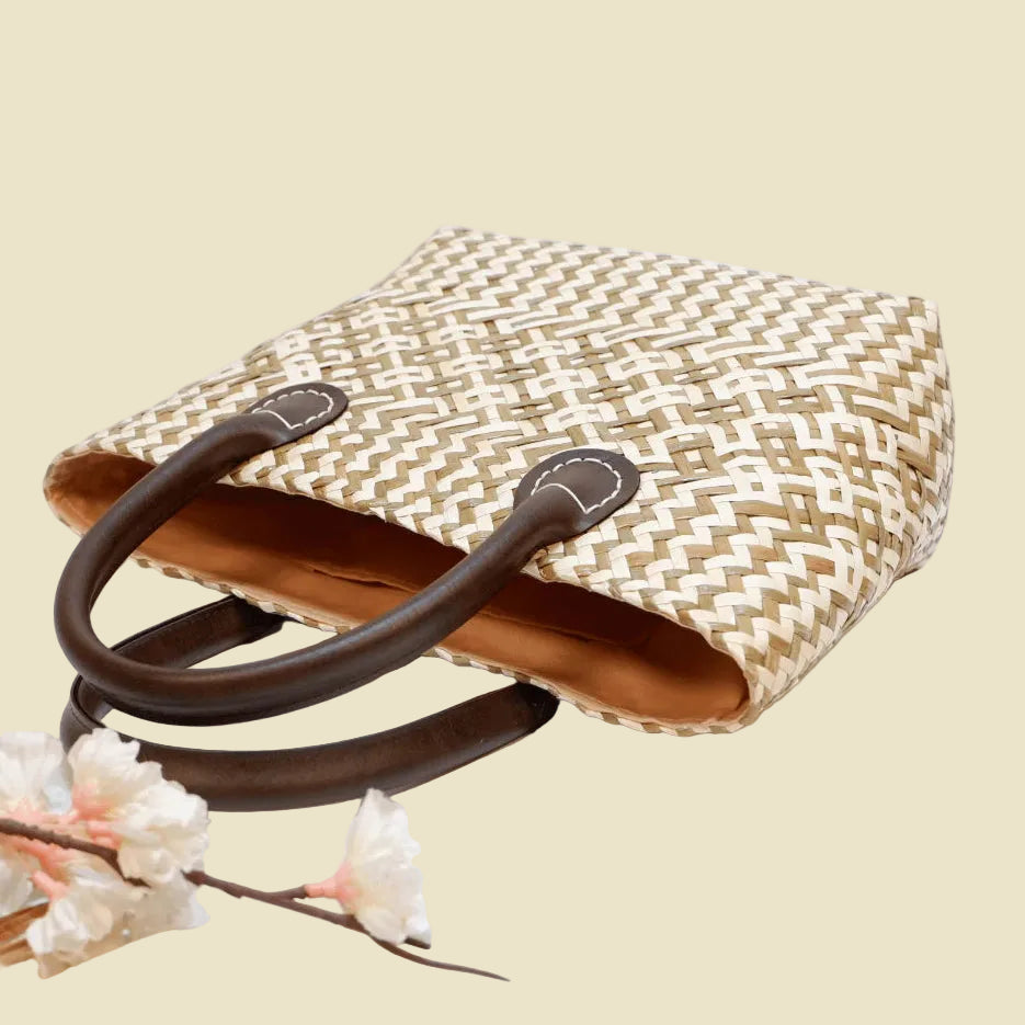 Durable handwoven seagrass boho tote bag with faux leather straps and fabric lining.