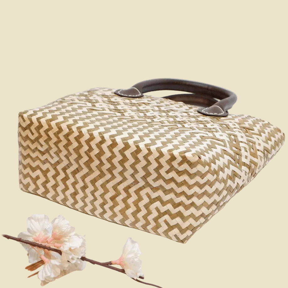 Durable handwoven seagrass boho tote bag with faux leather straps and fabric lining.