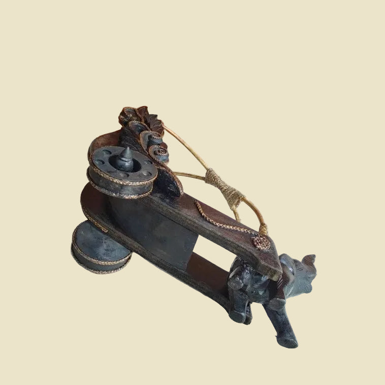 Handcrafted Thai elephant wine bottle holder carved from Rain Tree wood with a woven rattan barrel, premium artisan home decor.