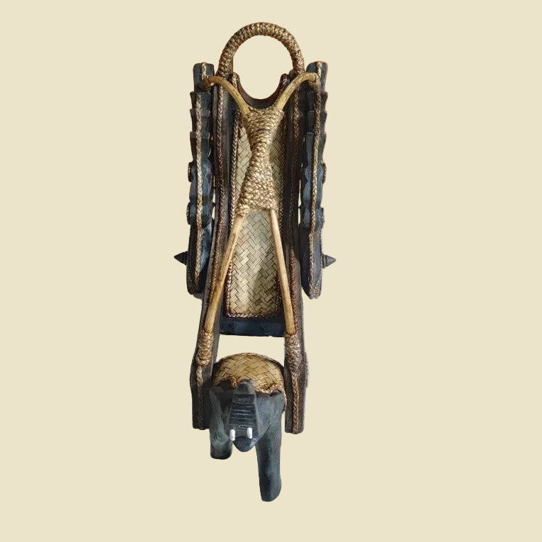 Handcrafted Thai elephant wine bottle holder carved from Rain Tree wood with a woven rattan barrel, premium artisan home decor.