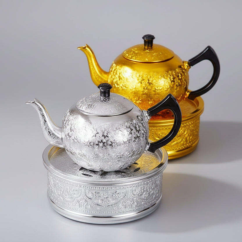Close-up of the rich, hand-pressed traditional Thai chisel pattern on a silver tin alloy teapot base.