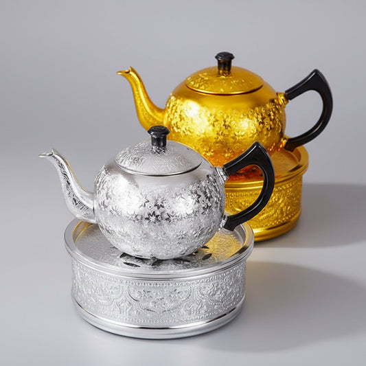 Close-up of the rich, hand-pressed traditional Thai chisel pattern on a silver tin alloy teapot base.
