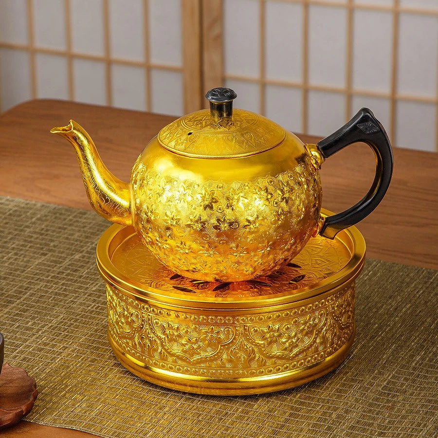 Close-up of the rich, hand-pressed traditional Thai chisel pattern on a silver tin alloy teapot base.