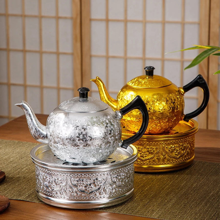 Close-up of the rich, hand-pressed traditional Thai chisel pattern on a silver tin alloy teapot base.