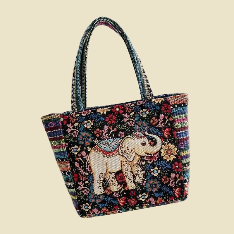 Woven canvas tote bag with colorful Thai elephant embroidery, featuring a zipper and boho-inspired design.