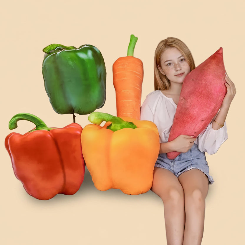A collection of giant soft vegetable plush toys including a carrot, sweet potato, and green, red, and orange bell peppers.