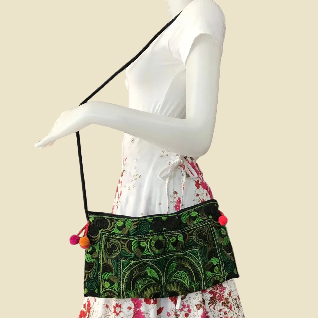 Handmade Hmong embroidered crossbody bag with colorful pom-poms and tribal patterns, authentic Thai bohemian shoulder purse.