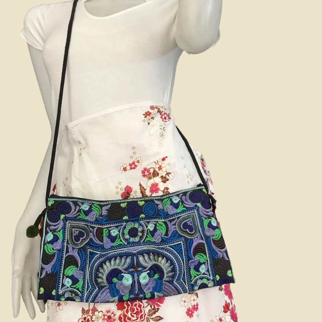 Handmade Hmong embroidered crossbody bag with colorful pom-poms and tribal patterns, authentic Thai bohemian shoulder purse.