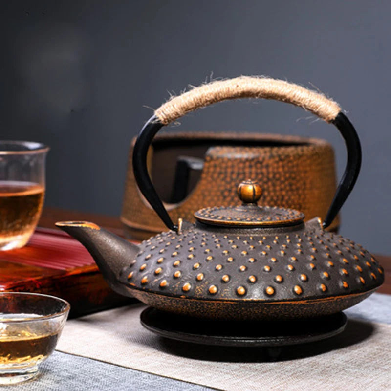 Premium 900ml floral cast iron kettle tea infuser featuring red blossoms and a rustic rope handle, perfect for tea lovers.