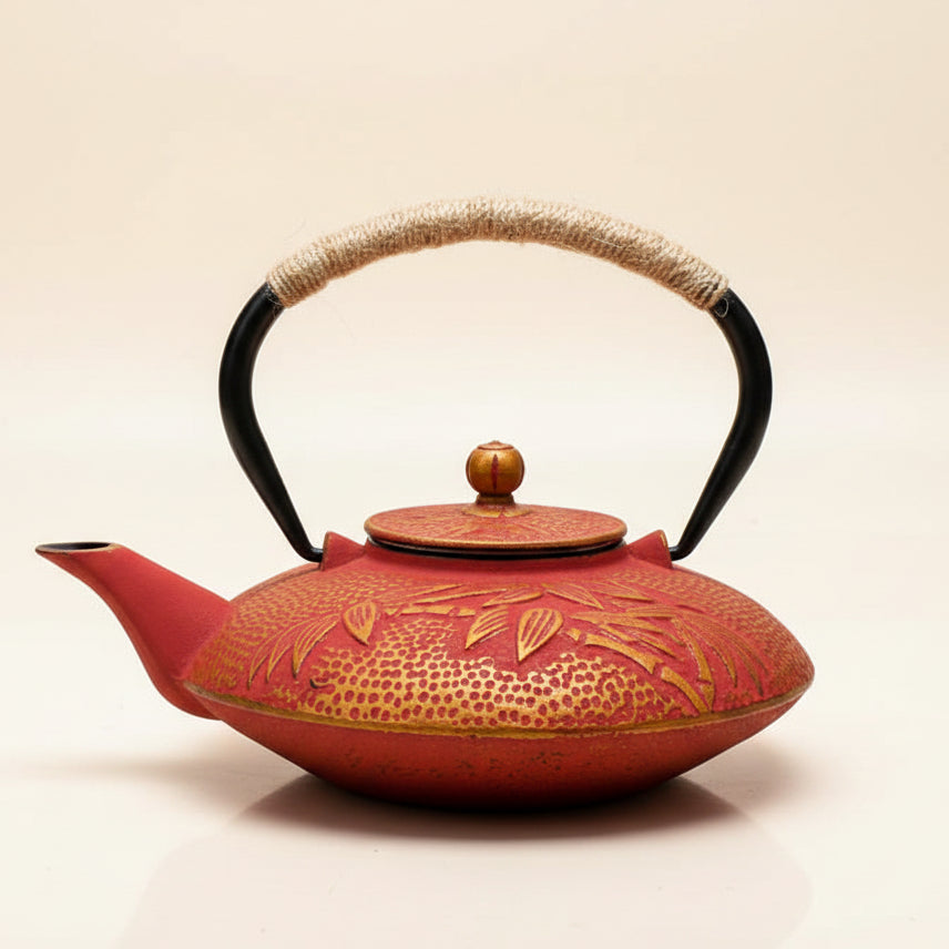 Premium 900ml floral cast iron kettle tea infuser featuring red blossoms and a rustic rope handle, perfect for tea lovers.