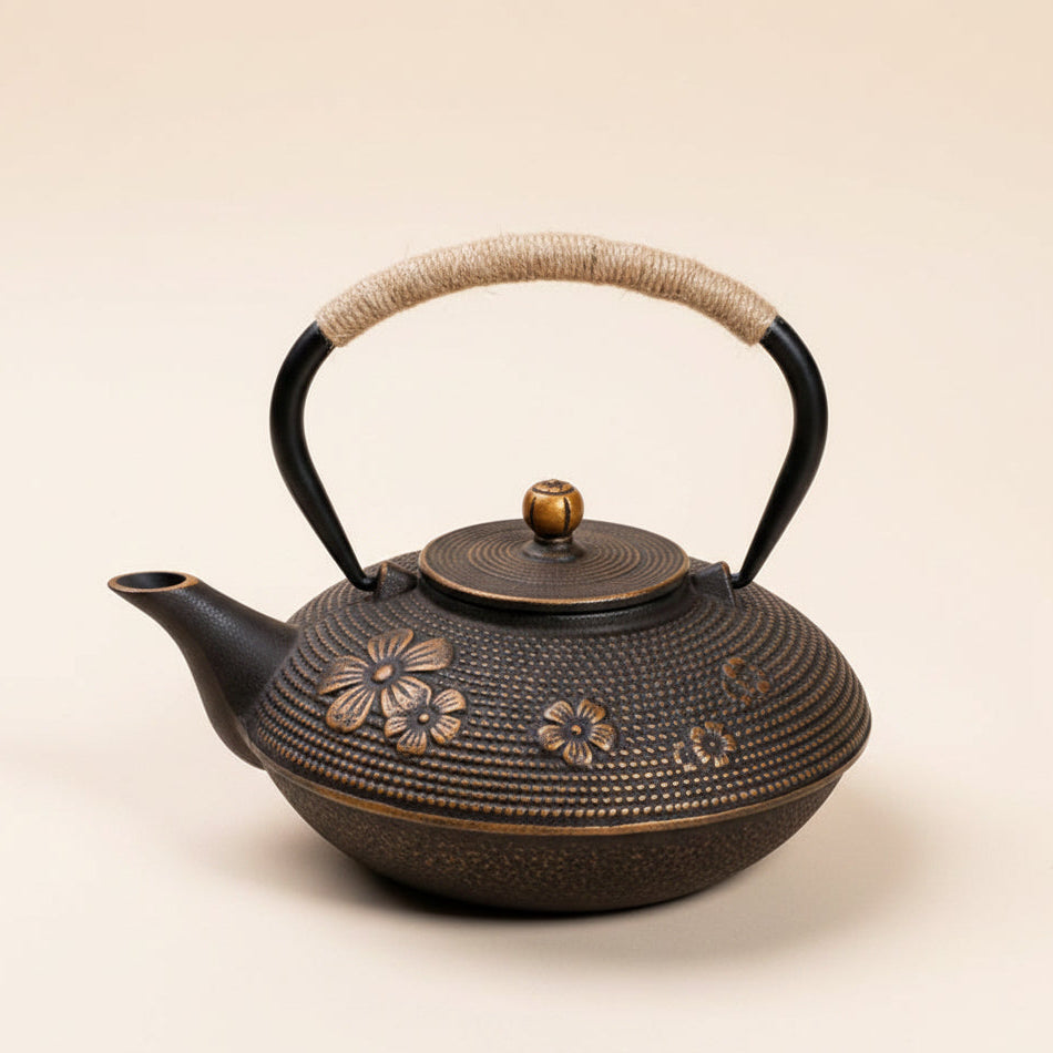 Premium 900ml floral cast iron kettle tea infuser featuring red blossoms and a rustic rope handle, perfect for tea lovers.