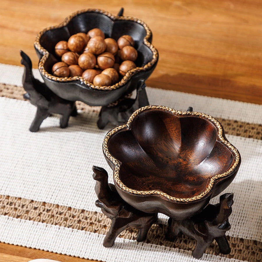 Hand-carved wooden elephant fruit tray with flower-shaped bowl and braided bamboo rim.