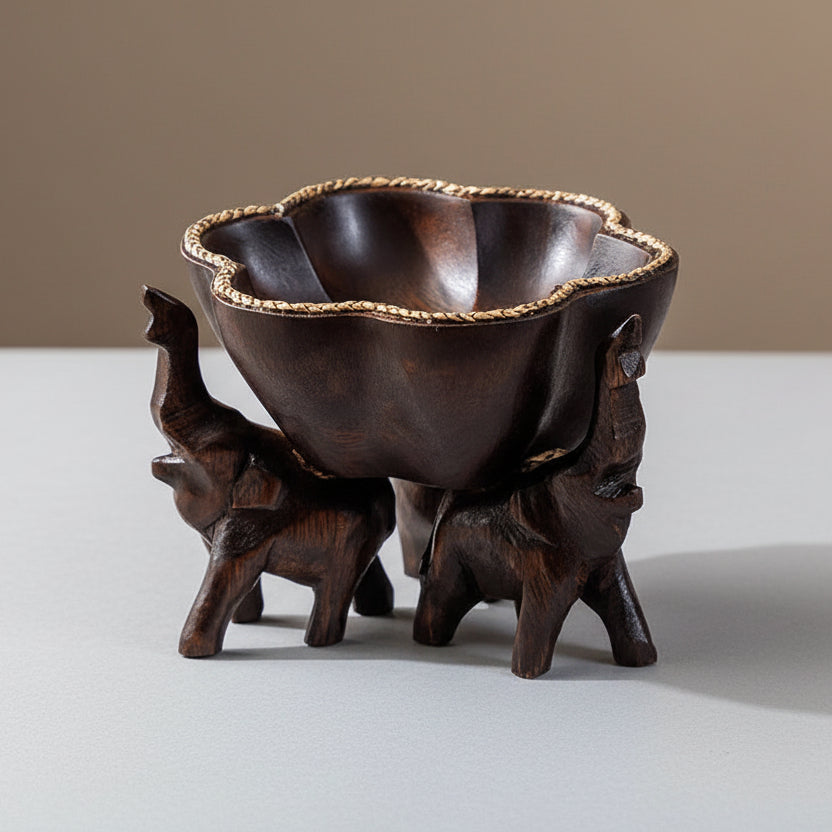 Hand-carved wooden elephant fruit tray with flower-shaped bowl and braided bamboo rim.