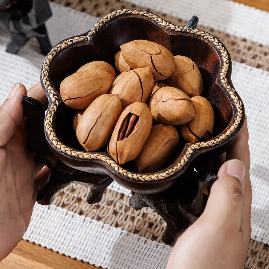 Hand-carved wooden elephant fruit tray with flower-shaped bowl and braided bamboo rim.