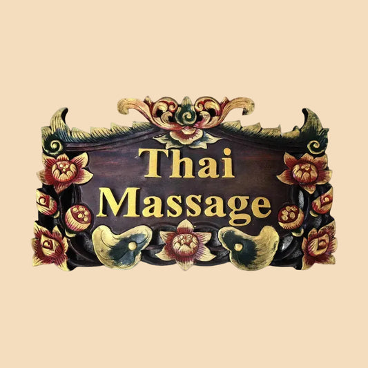 Hand-carved authentic teak wood sign reading Thai Massage with traditional floral details, ready to hang, perfect for spa and wellness shop decoration.