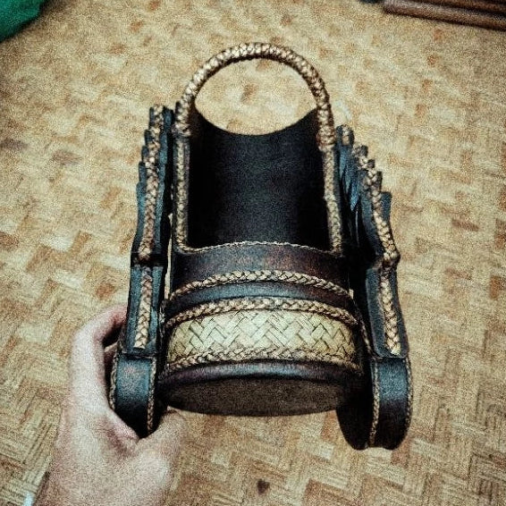 Handcrafted Thai elephant wine bottle holder carved from Rain Tree wood with woven rattan accents, model DC1010, premium tabletop decor.