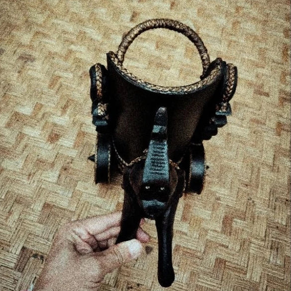 Handcrafted Thai elephant wine bottle holder carved from Rain Tree wood with woven rattan accents, model DC1010, premium tabletop decor.