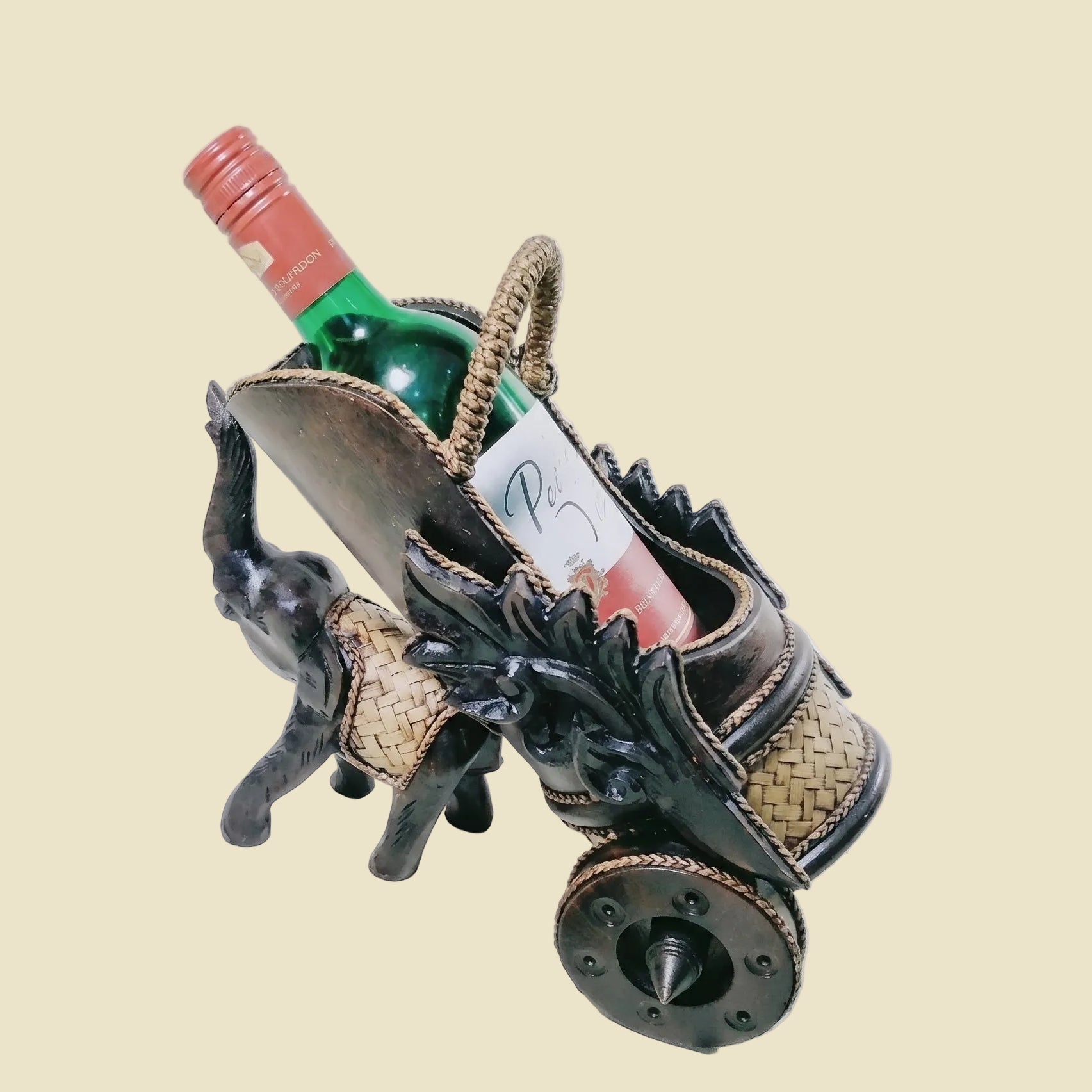Handcrafted Thai elephant wine bottle holder carved from Rain Tree wood with woven rattan accents, model DC1010, premium tabletop decor.