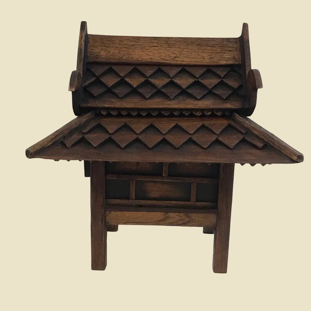 Handcrafted authentic Thai teak wood miniature spirit house and traditional Zen shrine.