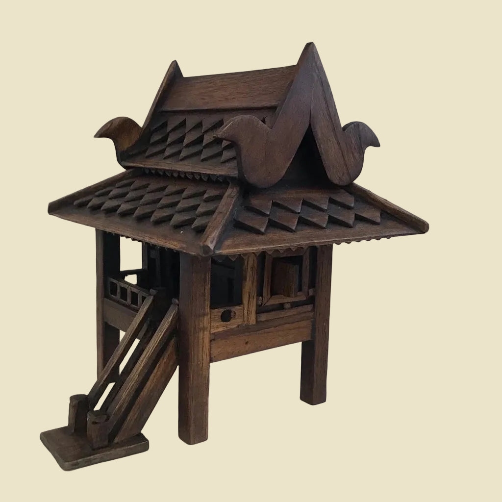 Handcrafted authentic Thai teak wood miniature spirit house and traditional Zen shrine.