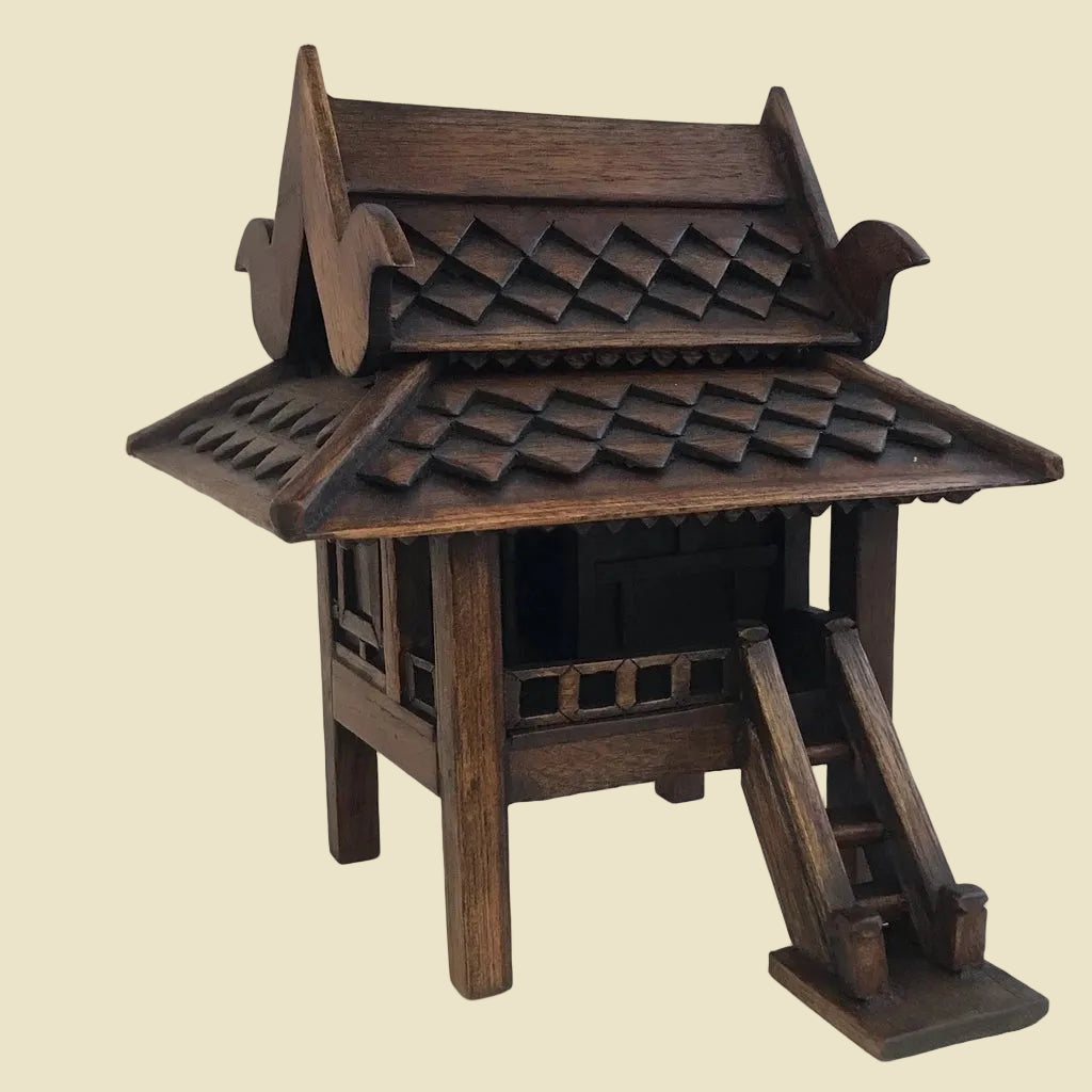 Handcrafted authentic Thai teak wood miniature spirit house and traditional Zen shrine.