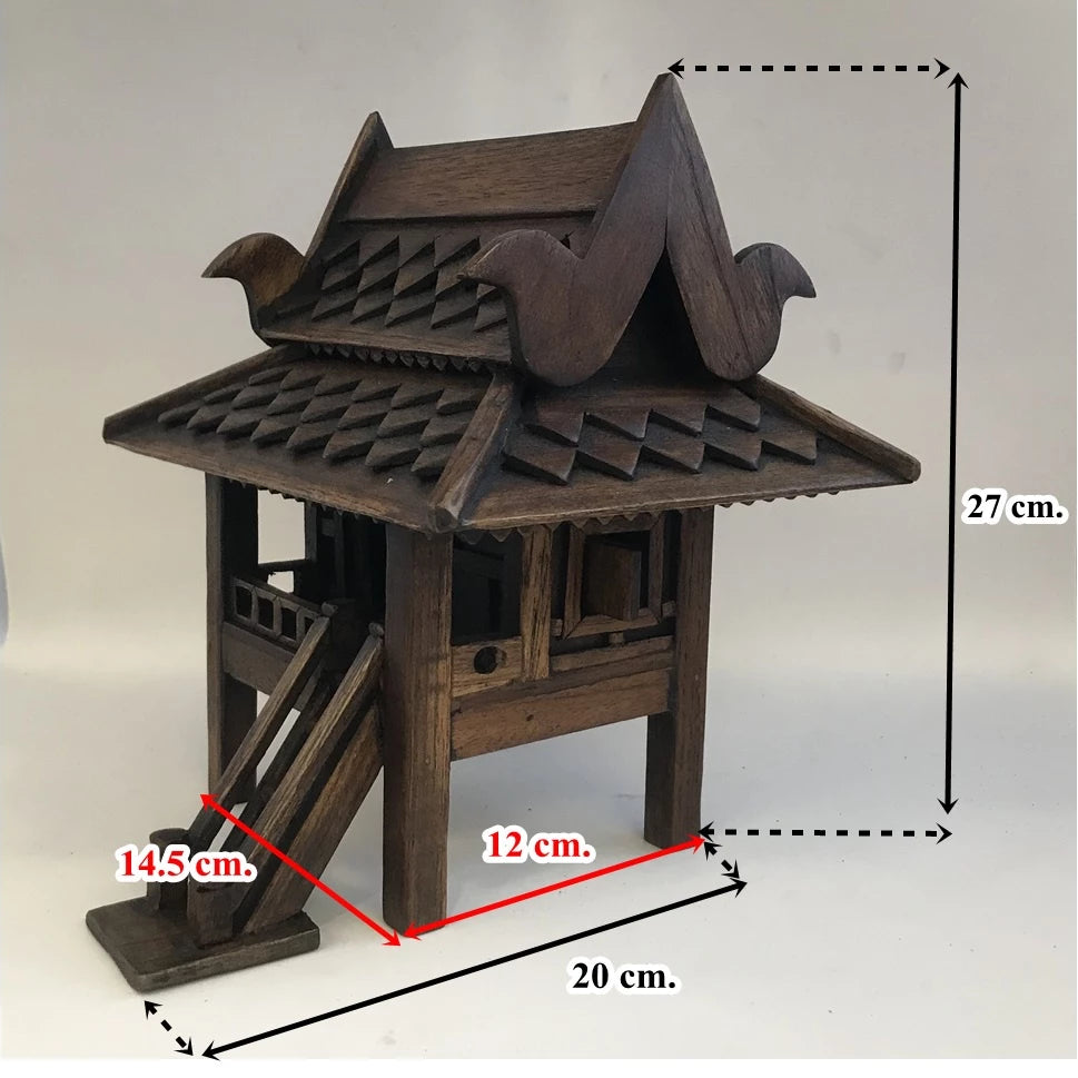 Handcrafted authentic Thai teak wood miniature spirit house and traditional Zen shrine.
