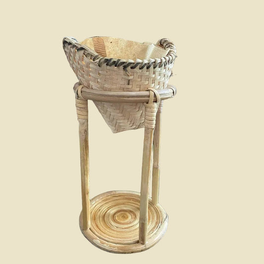 Hand-woven bamboo coffee dripper set with rattan stand on cream background