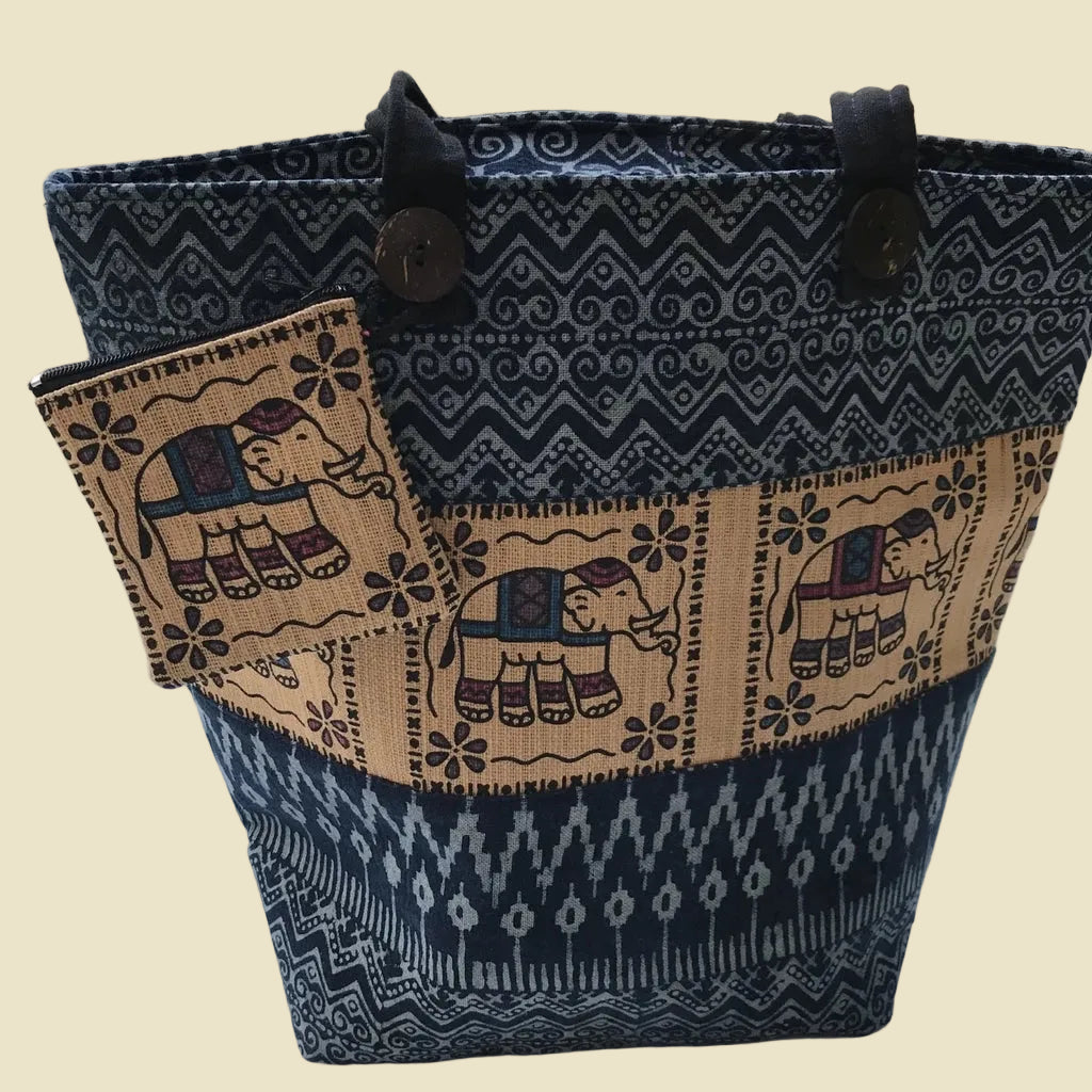 Handmade Northern Thai indigo dyed cotton shoulder bag with batik patterns and Hmong embroidery, featuring coconut shell button.