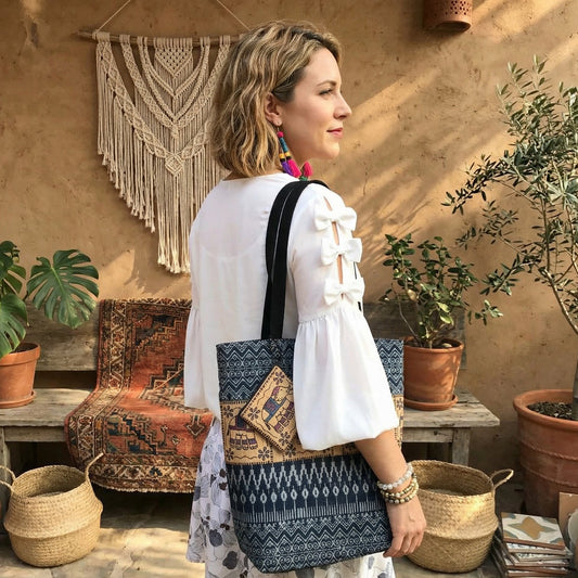 Handmade Northern Thai indigo dyed cotton shoulder bag with batik patterns and Hmong embroidery, featuring coconut shell button.