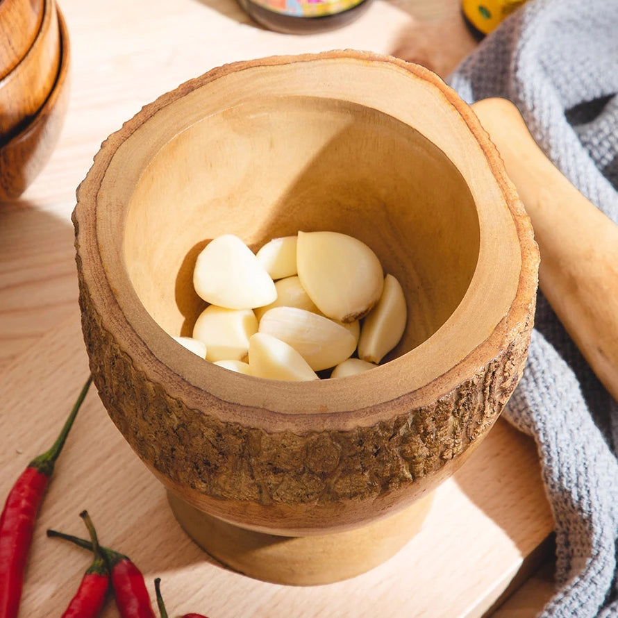 Close-up of a thick-walled wooden mortar bowl showing the 2.5cm depth for easy garlic grinding.