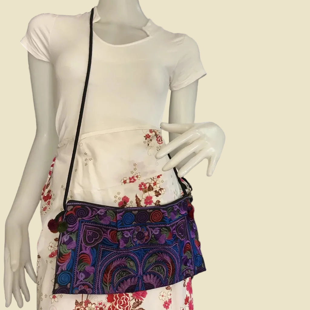Handmade Hmong embroidered crossbody bag with colorful pom-poms and tribal patterns, authentic Thai bohemian shoulder purse.