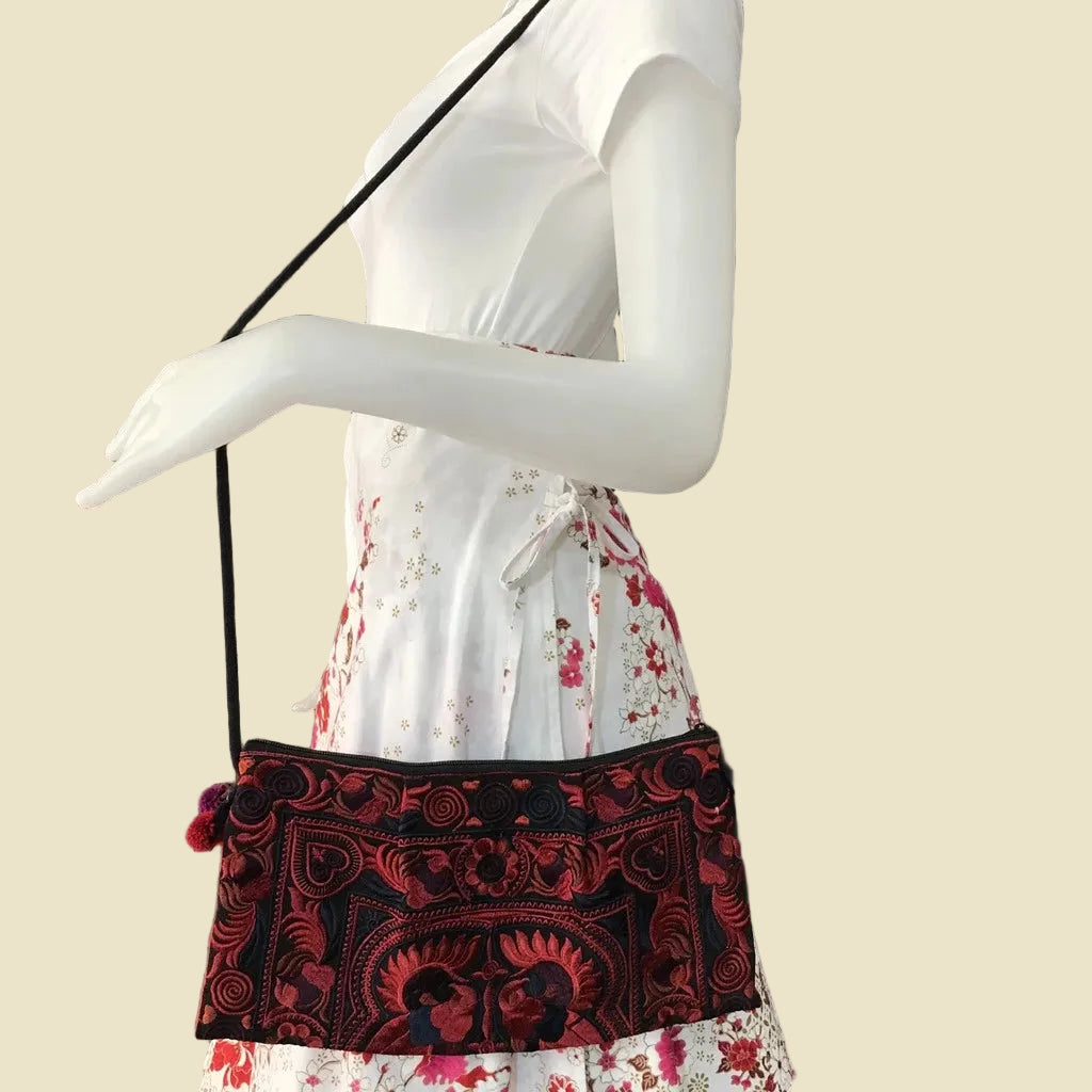 Handmade Hmong embroidered crossbody bag with colorful pom-poms and tribal patterns, authentic Thai bohemian shoulder purse.