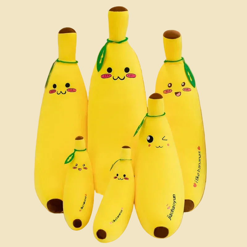 Three yellow giant banana plush body pillows in different sizes, featuring cute kawaii embroidered faces