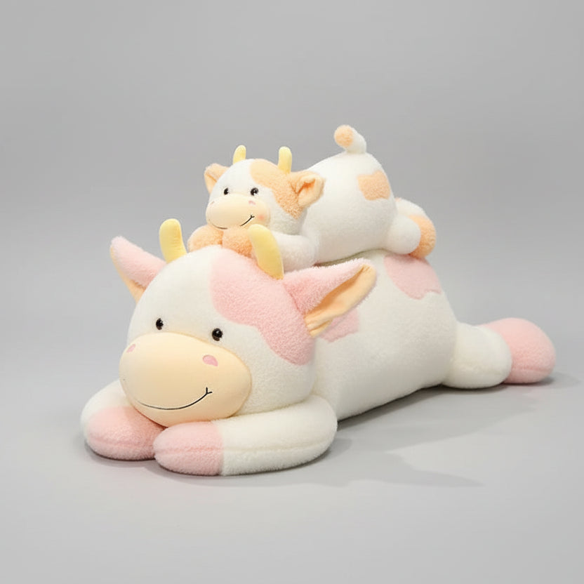 Girl sleeping with large soft cow stuffed animal body pillow