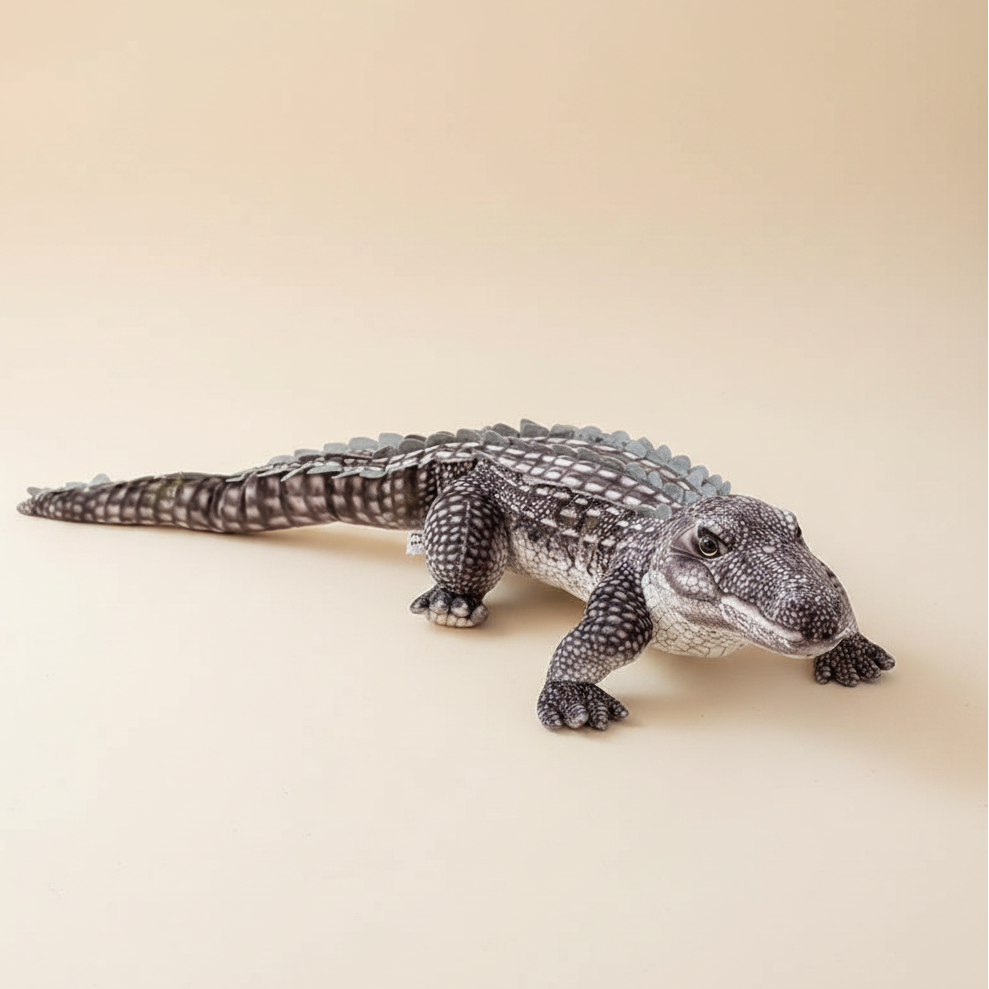 Giant realistic crocodile plush toy body pillow on a bed