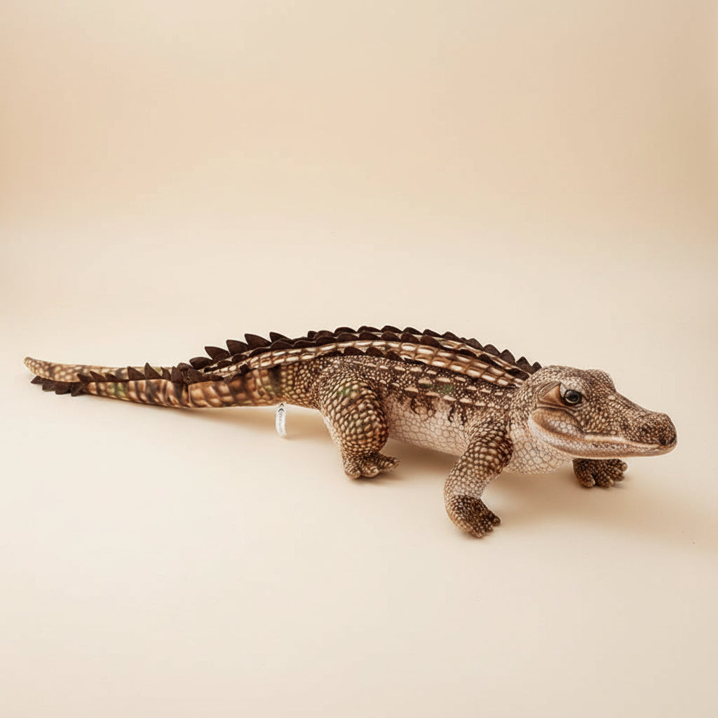 Giant realistic crocodile plush toy body pillow on a bed