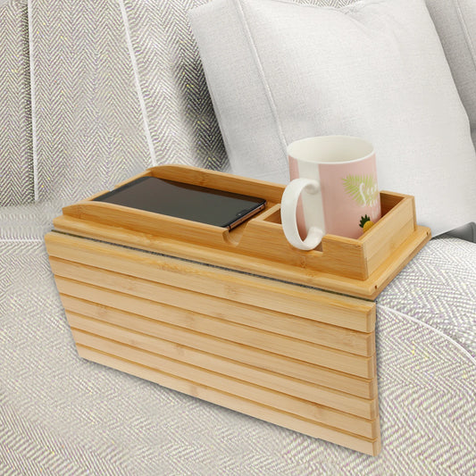 Light bamboo wood sofa tray table with a built-in cup holder and phone slot, resting securely on a couch armrest