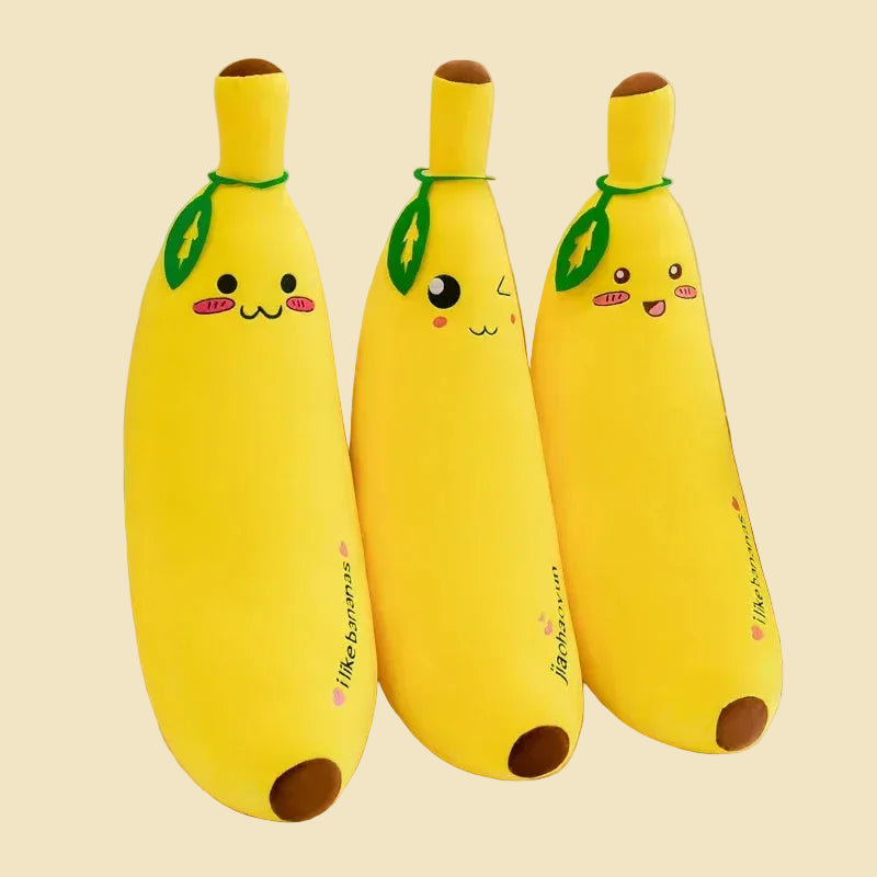 Three yellow giant banana plush body pillows in different sizes, featuring cute kawaii embroidered faces