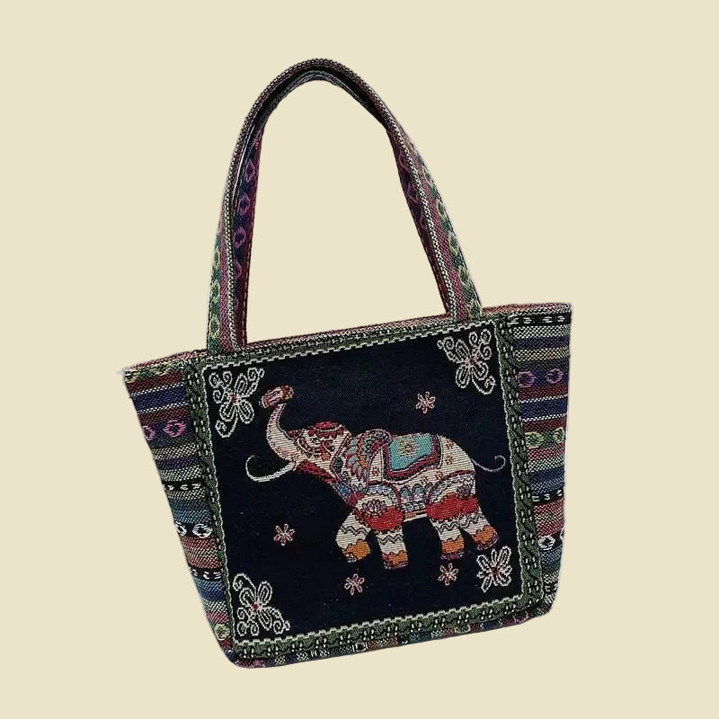 Woven canvas tote bag with colorful Thai elephant embroidery, featuring a zipper and boho-inspired design.