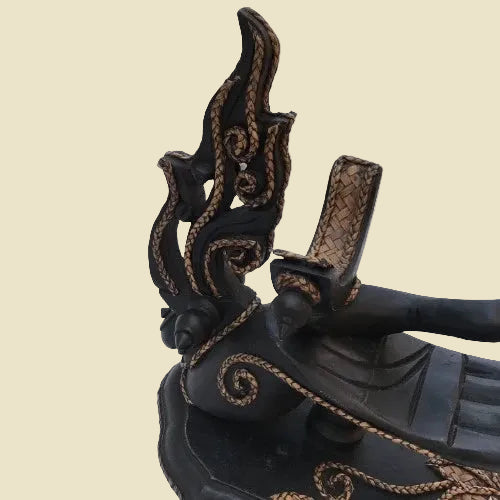 Unique handcrafted Thai Rain Tree wood wine bottle holder in a hand-shaped design with woven rattan accents, displayed on a tabletop.