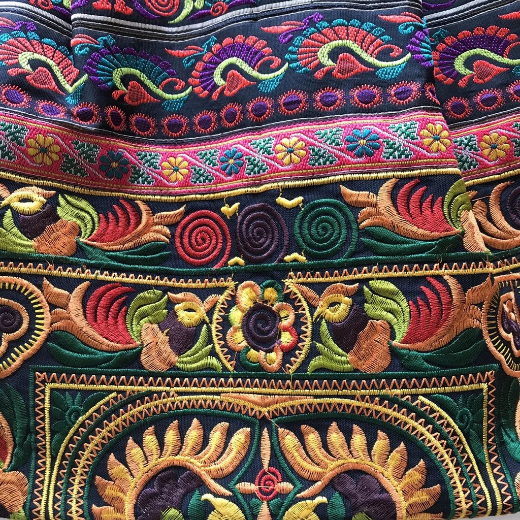 Vibrant handcrafted Thai Hmong tribal embroidered shoulder bag with colorful pom-poms and zipper closure, authentic bohemian style.