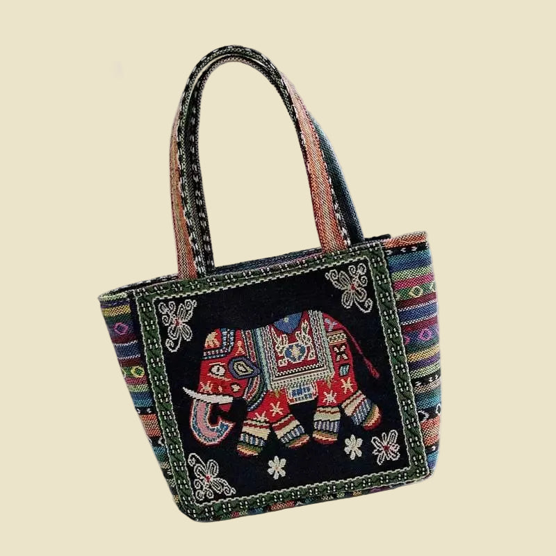Woven canvas tote bag with colorful Thai elephant embroidery, featuring a zipper and boho-inspired design.